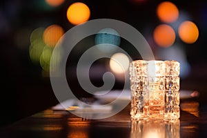 Close up candle light on dinner table with colorful bokeh at night