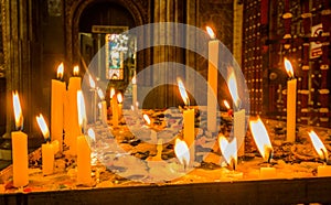 Close up of candles over a metallic structure inside of Santo Domingo Church in Quito, Ecuador photo