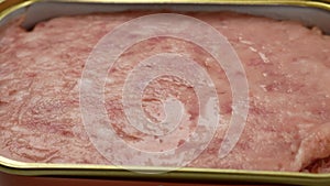 close up of canned meat on table