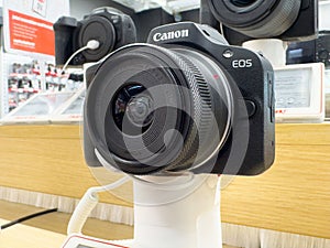 Close-up of canon eos camera on display in electronics store