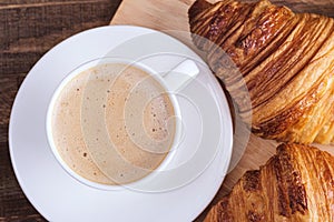 Close-up cap coffee cappuccino and croissant