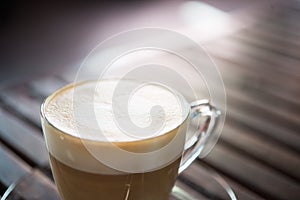 Close up of cappuccino cup with heart shaped milk pattern at cafe. a cup of coffee art.