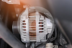 Close up car alternator in the car background. Automotive concept