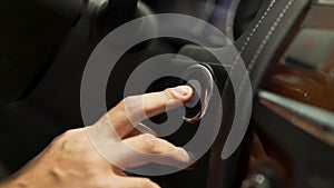 Close up for car driver starting the engine of the modern vehicle, modern technologies concept. Stock. Man finger