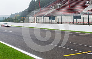 Close up of car driving on speedway track or road