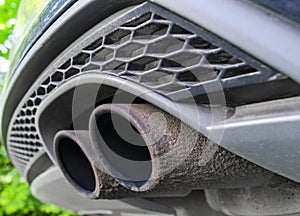 Close up of a car dual exhaust pipe. Double exhaust pipes of a modern sports car. Car exterior details