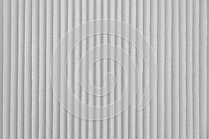 Close-up on a car filter for a white engine as a background with vertical stripes. Spare parts for vehicles, repairs and