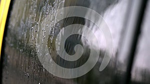 close-up, on the car glass windows rain drops drip down a multitude of streams. it's raining heavily, downpour