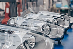 Close up of car headlamps, headlights in a row ready for assembly to the car, automotive industry concept