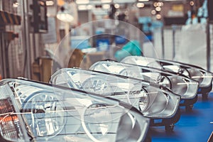 Close up of car headlamps, headlights in a row ready for assembly to the car, automotive industry concept