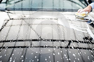 Close-up of a car hood during the washing process