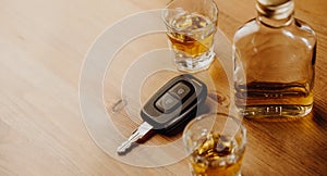 Close up of a car keys and very strong alcohol on the table, do not drink and drive concept