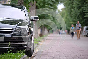 Close up of a car parked on city street side. Urban traffic concept