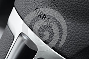 Close up of a car steering wheel airbag