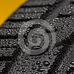 Close up from a car tire with rain drops aquaplaning