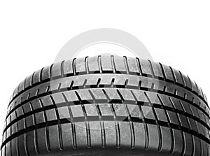 Close-up of car tire tread pattern on white background