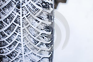 Close up car tires covered with snow. Winter tyres in extreme cold temperature