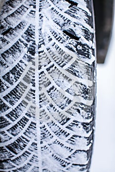 Close up car tires covered with snow. Winter tyres in extreme cold temperature