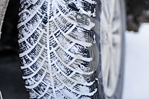 Close up car tires covered with snow. Winter tyres in extreme cold temperature