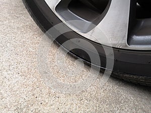 Close-up car tires have a tear on the sidewall. Flat tire on a car photo