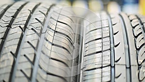 Close-up of Car Tires and then a Stack of Tires in the Back