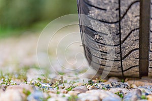 Close up of car tyre tread on the road on a bright day