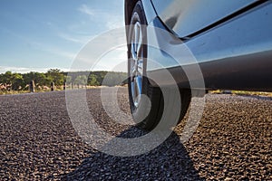 Close up of car wheels on asphalt road