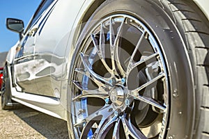 Close up of a car& x27;s rim, wheel with no emblem chrome rims and bl photo