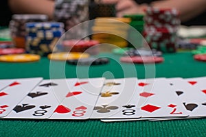 Close-up cards for playing poker on a gaming table in a casino against a background of chips. Background for a gaming business