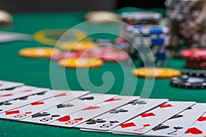 Close-up cards for playing poker on a gaming table in a casino against a background of chips. Background for a gaming business