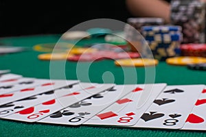 Close-up cards for playing poker on a gaming table in a casino against a background of chips. Background for a gaming business