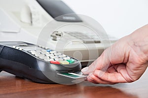 Close-up of cards servicing with POS-terminal photo