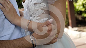 Close-up caressing hands of newlyweds. Action. Gentle touch of hands of loving couple of newlyweds. Beautiful and