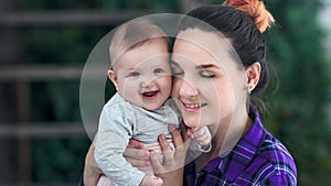 Close-up caring lovely mother having tenderness love feeling kissing her little baby and smiling