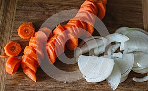 Close up on carot and onion on wooden background photo