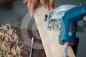 Close-up of a carpenter using a circular saw.