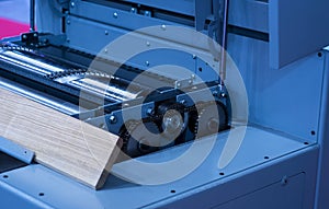 Close-up of a carpenter using a circular saw to cut a large board of wood