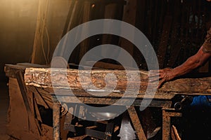 Close-up of a carpenter using a circular saw or a tool .