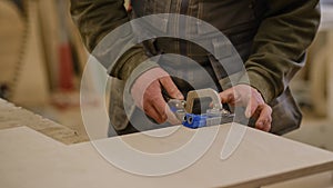 Close up. Carpenter work in the workshop. Woodwork and furniture making concept. Carpenter in the workshop marks out and