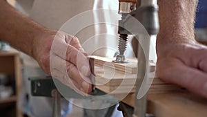 Close up of a carpenter working on wood craft at workspace producing wooden furniture.with professional tools for