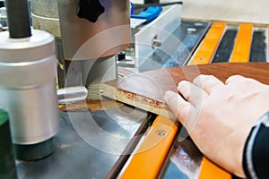 Close-up Carpenter works for Edge Banding Machine In workshop