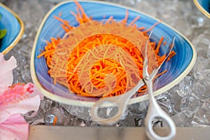 Close up of carrot salad, vegetarian bar with assortment of ingredients