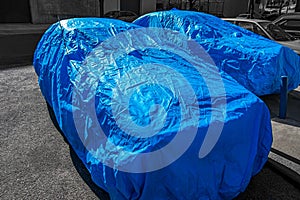 Close-up of cars covered with covers