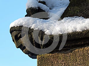 Close up of the carving of a womans face in profile on the corner of the ancient ruined medieval church in heptonstall