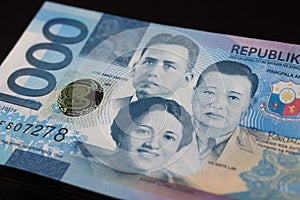 Close up of cash banknote of one thousand Philippines peso on black background, macro