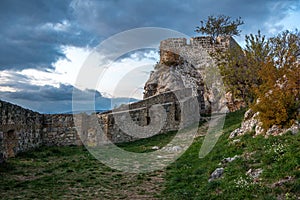 Close up of castle walls and tower on the top of the hill.