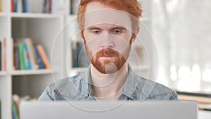 Close Up of Casual Redhead Man Working On Laptop