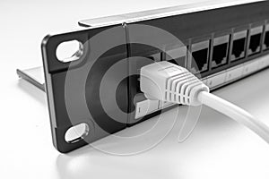 Close-up of a Cat5e 24-Port Patch Panel showing an Ethernet Patch Lead connected to Port one of the panel.