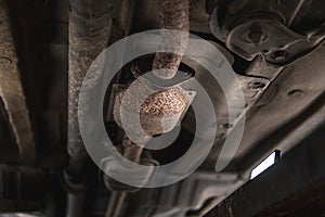 Close-up of Catalytic Converter in Car Exhaust System. The concept of preserving ecology, reducing harmful emissions into the air