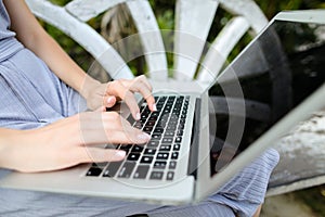 Close up caucasian female hands using laptop, typing message on keyboard.